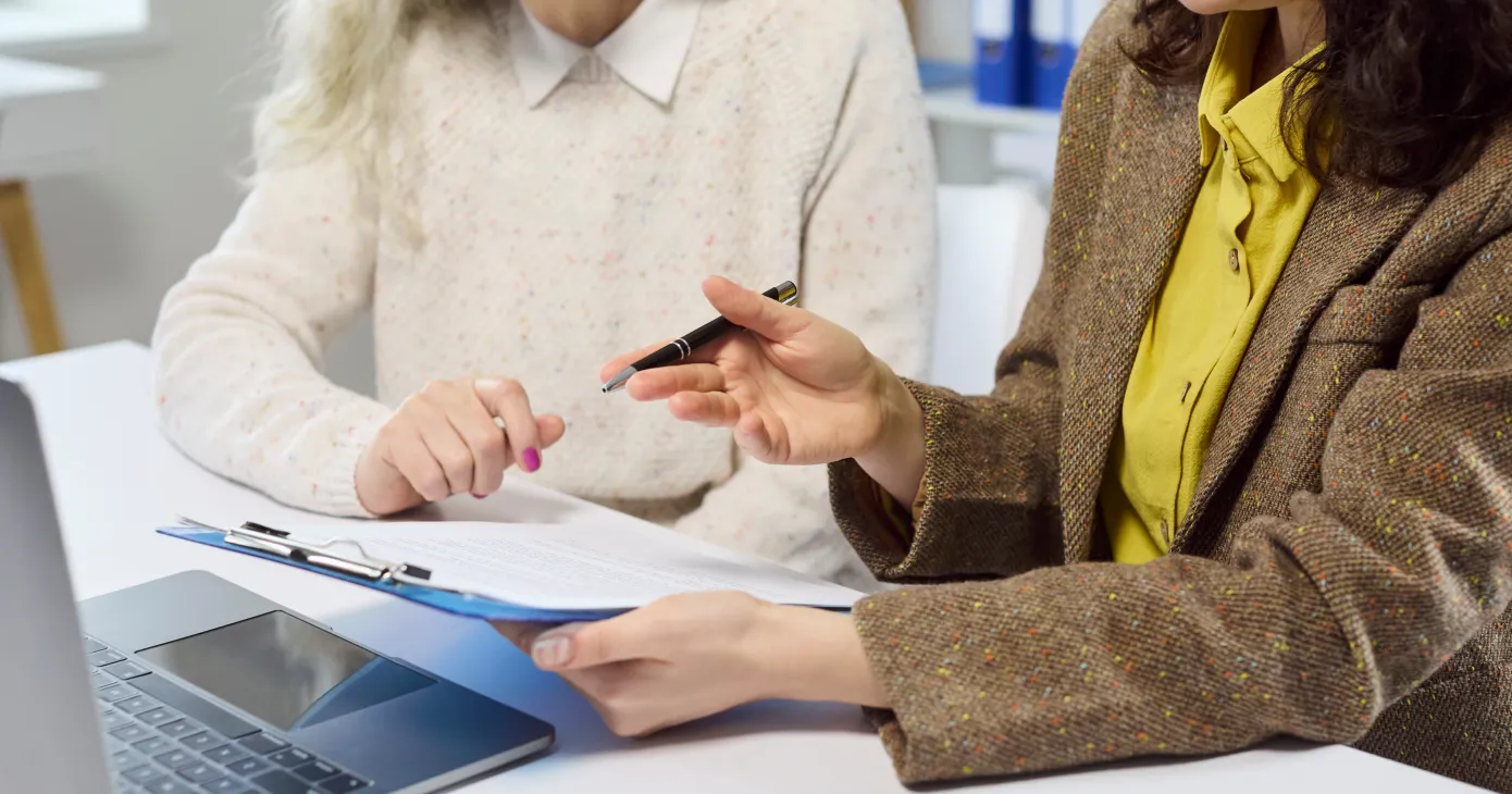 Senior woman with advisor signing contract